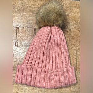 Pink toque/beanie with pompom.